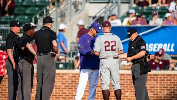 Texas A&M head coach Jim Schlossnagle and TCU head coach Kirk Saarloos meet at home plate before the College Station Regional final.